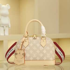 This Alma BB handbag from the Travels With Grace Coddington collection, a collaboration between Louis Vuitton and Grace Coddington, features the playful Meowgram pattern. The canvas body is accented with calf leather trim, while the fabric shoulder strap displays "Louis Vuitton" in Coddington's handwriting. The refined padlock and key pouch further showcase the brand's exceptional craftsmanship.17.5 x 11.5 x 23.5 cm (Height x Width x Length)